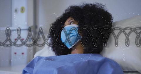 Woman patient wearing mask resting on hospital bed with vital-sign waveform overlay