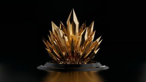 Golden faceted crystal crown sculpture on matte black pedestal reflecting warm light