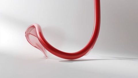 Glossy red curved tube with glass droplet tip, minimal abstract sculpture