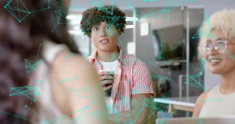 Young professional holding coffee during coworking collaboration with turquoise network overlay