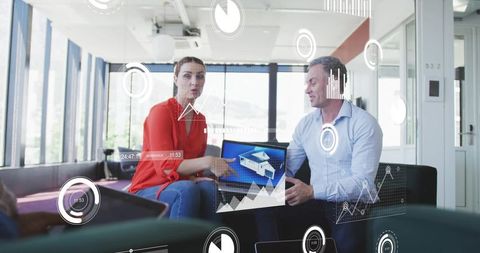 Colleagues Collaborating with Digital Charts in Modern Office