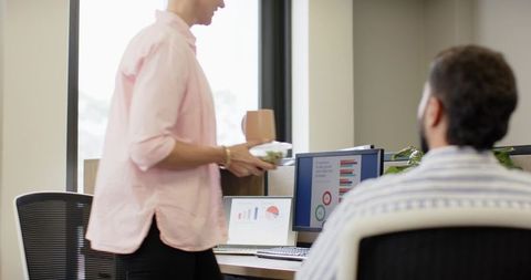 Coworkers Collaborating in Modern Office with Dual Monitors