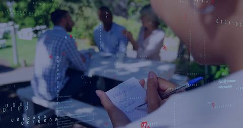 Noting during outdoor team meeting with binary code overlay for data-driven collaboration