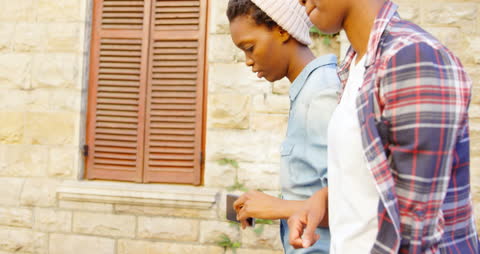 Sisters Walking in City, Smiling and Enjoying Day Together
