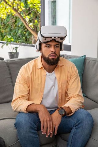 Man Using Virtual Reality Headset in Modern Living Room