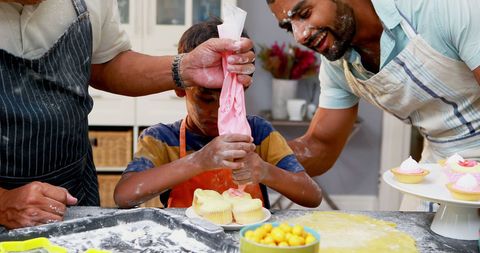 Family baking fun: child learning cupcake decoration