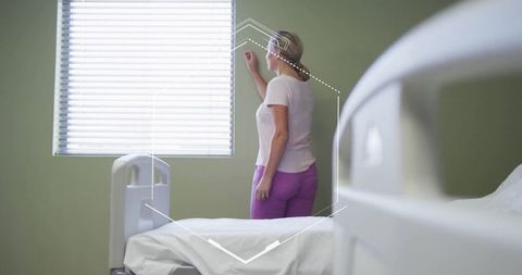 Woman adjusting hospital blinds serene healthcare environment