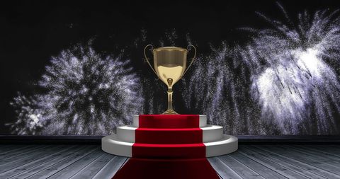 Gold trophy on red carpet with spectacular fireworks