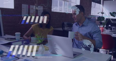 Colleagues Reviewing Digital Charts in Modern Office