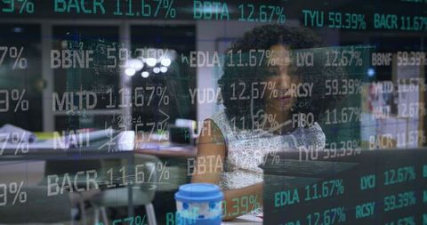 African American Businesswoman Analyzing Data on Laptop at Night