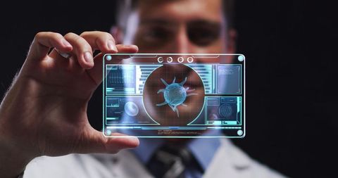 Scientist Analyzing COVID-19 Cell on Futuristic Digital Screen