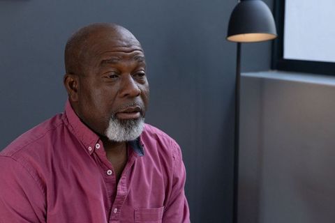 Senior man relaxing in contemporary minimalist lounge area