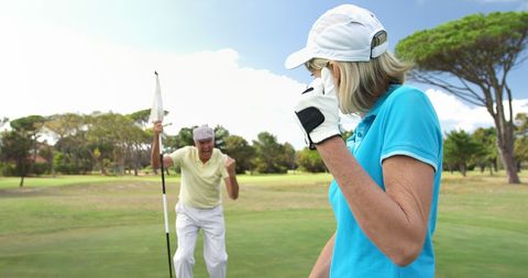 Excited Senior Golfers Celebrating on Golf Course