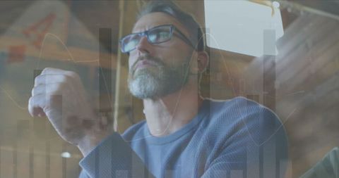 Pensive Businessman with Growing Financial Charts Overlay