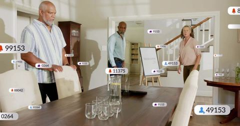 Hybrid home meeting with hosts gathered at dining table, virtual engagement icons floating
