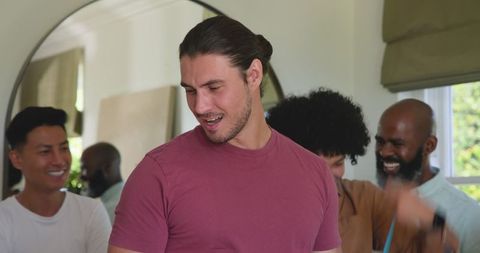 Close group of friends celebrating with smiles and laughter at home gathering