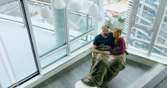 Couple Relaxing Indoors in Modern High-Rise Apartment - Download Free Stock Images Pikwizard.com