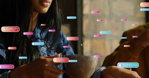 Holding ceramic cup in coffeehouse surrounded by floating social media notification tags