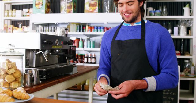 Smiling Barista Counting Cash in Small Cafe - Download Free Stock Images Pikwizard.com