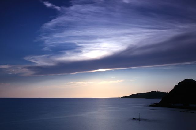 Tranquil Twilight Over Calm Sea with Mountains - Download Free Stock Photos Pikwizard.com