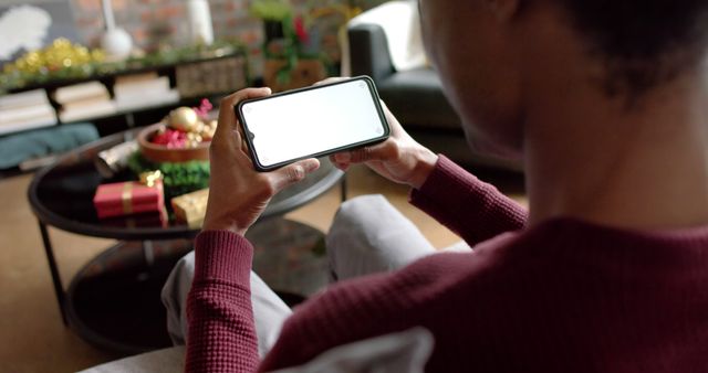 Man Relaxing and Browsing on Smartphone in Cozy Living Room - Download Free Stock Images Pikwizard.com