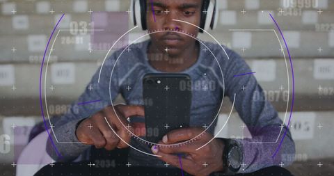 Male Athlete Analyzing Performance with Smartphone and Headphones - Download Free Stock Images Pikwizard.com