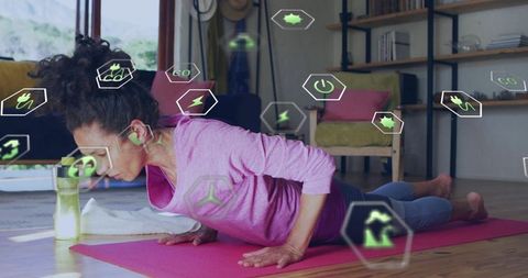 Woman doing low chaturanga on pink mat with augmented reality fitness hud