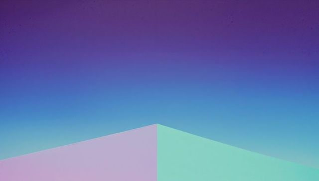 Colorful geometric triangle against gradient turquoise backdrop