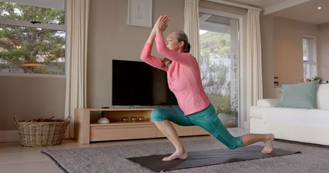 Senior Woman Practicing Yoga at Home for Wellness and Flexibility