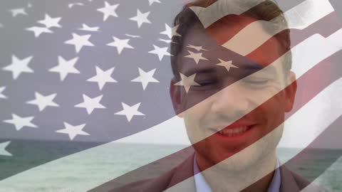 Double Exposure of American Flag and Young Man Smiling at Beach