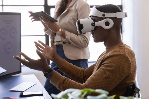 Diverse Team Using VR Headset Collaborating on Data Visualization for Tech Innovation