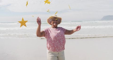 Joyful Woman Celebrated on Beach with Star Confetti in Ocean Breeze
