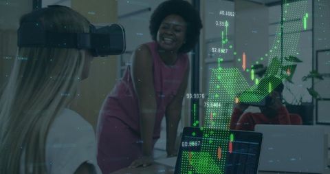 Businesswomen Engaged with VR Tech and Financial Graphs in Modern Office