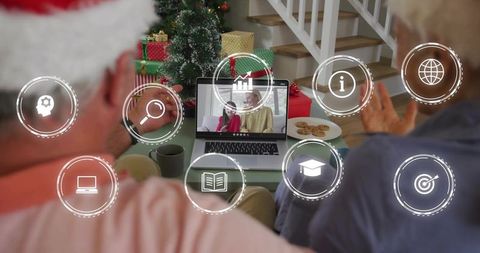 Senior couple waving on holiday video call with family, christmas tree and wrapped gifts