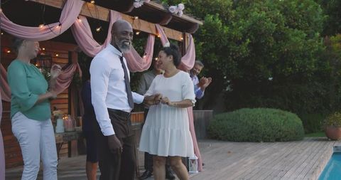 Joyful Wedding Celebration with Happy Senior Friends in Garden