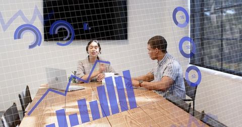 Business team discussing data visualization with augmented reality in conference room