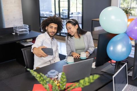 Coworkers Taking Selfie During Office Celebration