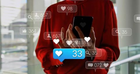 Professional woman in red tapping smartphone and receiving social media notifications