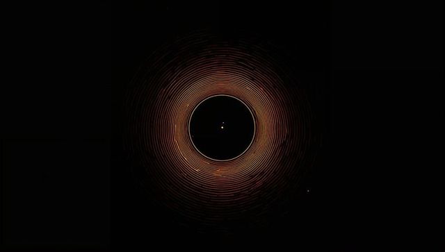 Golden concentric halo radiating around dark core with central glow and orbiting dot