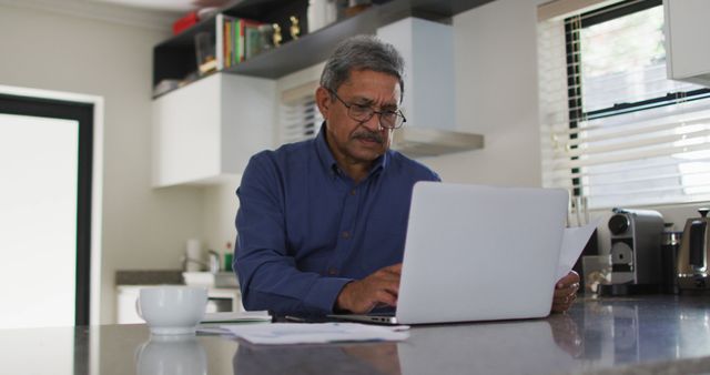 Senior Man Using Laptop in Bright Kitchen - Download Free Stock Images Pikwizard.com