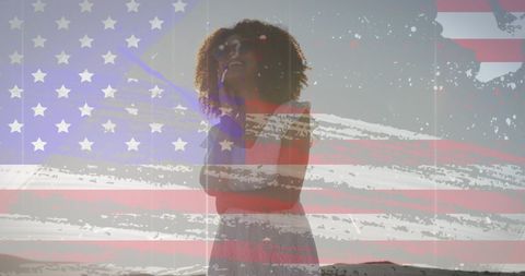 Joyful African American Woman with USA Flag Overlay at Beach