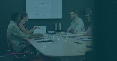 Diverse Team Engages in Lively Office Discussion with Data Visualizations