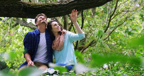Young Couple Enjoying Nature Walk in Lush Forest