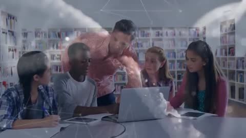 Teacher Guiding Students with Laptop in Library Group Study