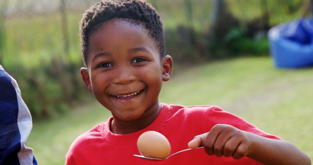 Joyful Child Enjoying Egg-and-Spoon Race Outdoors - Download Free Stock Images Pikwizard.com