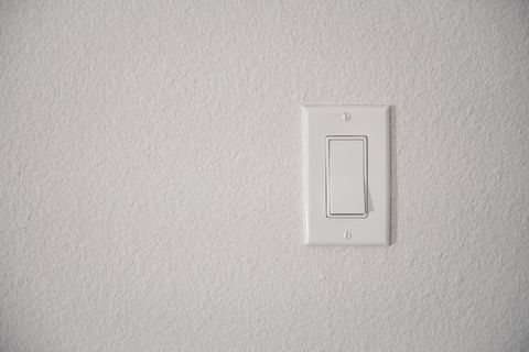 Modern Light Switch Turned Off on White Wall