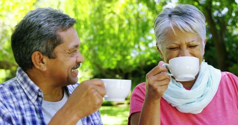 Senior Couple Enjoying Coffee Outdoors in Relaxing Environment