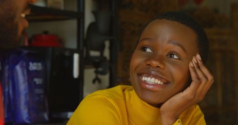 Joyful young girl smiling engaged in conversation indoors