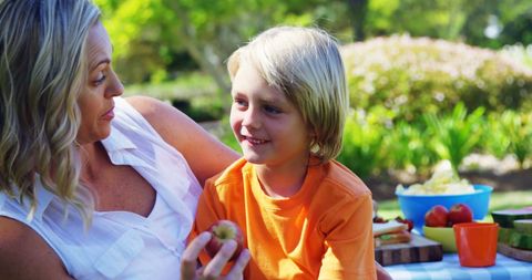 Mother and Son Bonding During a Family Picnic Outdoors