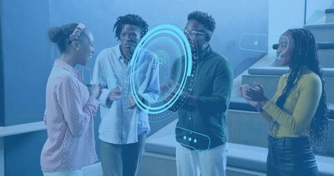 Team collaborating around holographic ar interface in modern tiered workspace